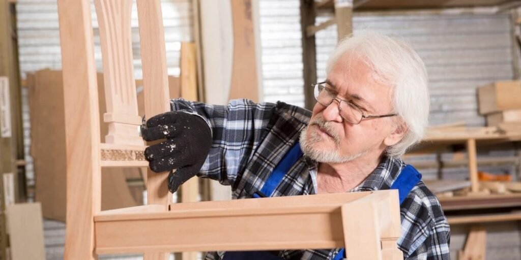 old man completing his chair woodworking project